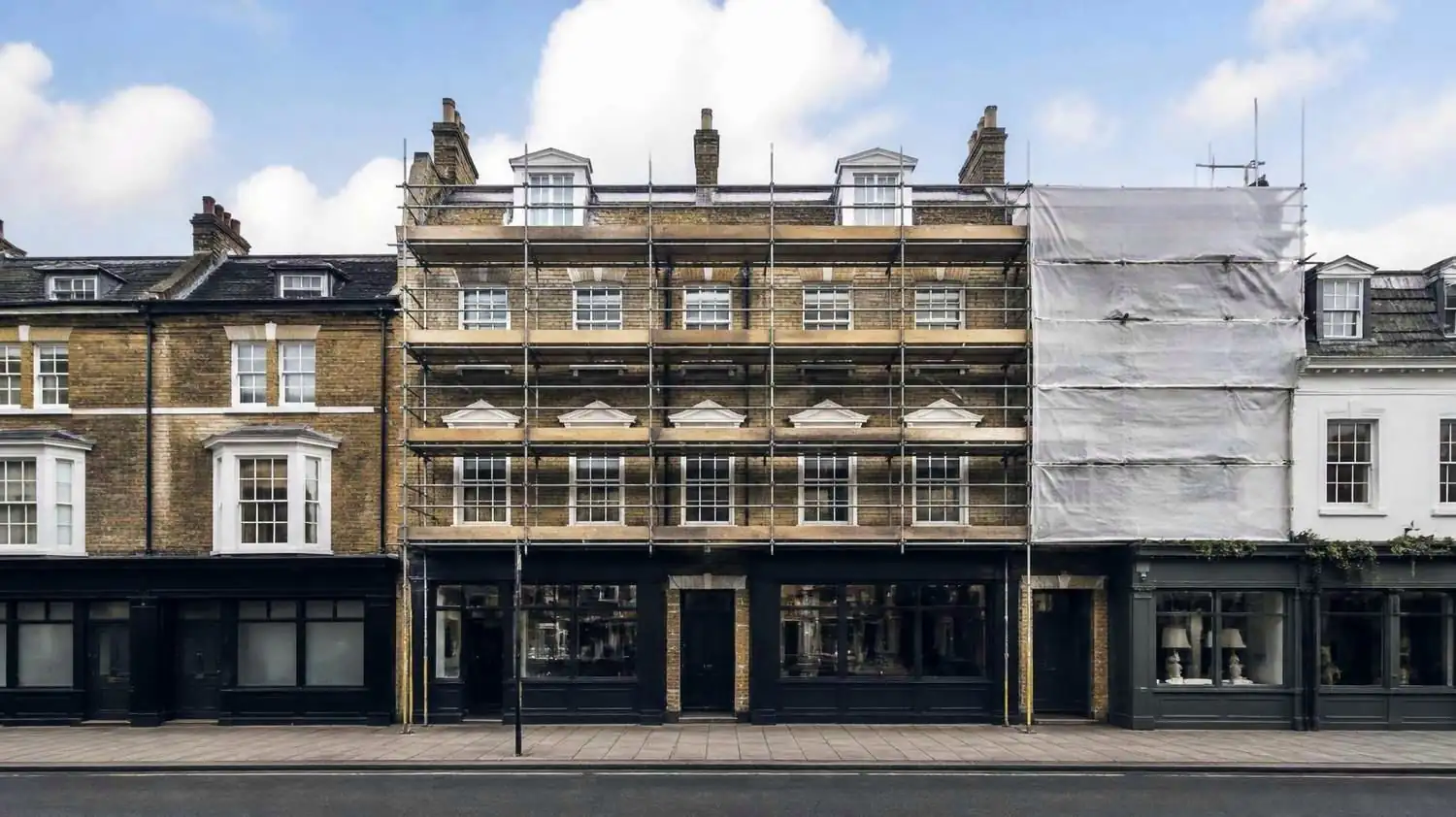 A period high street building under refurbishment, covered in scaffolding
